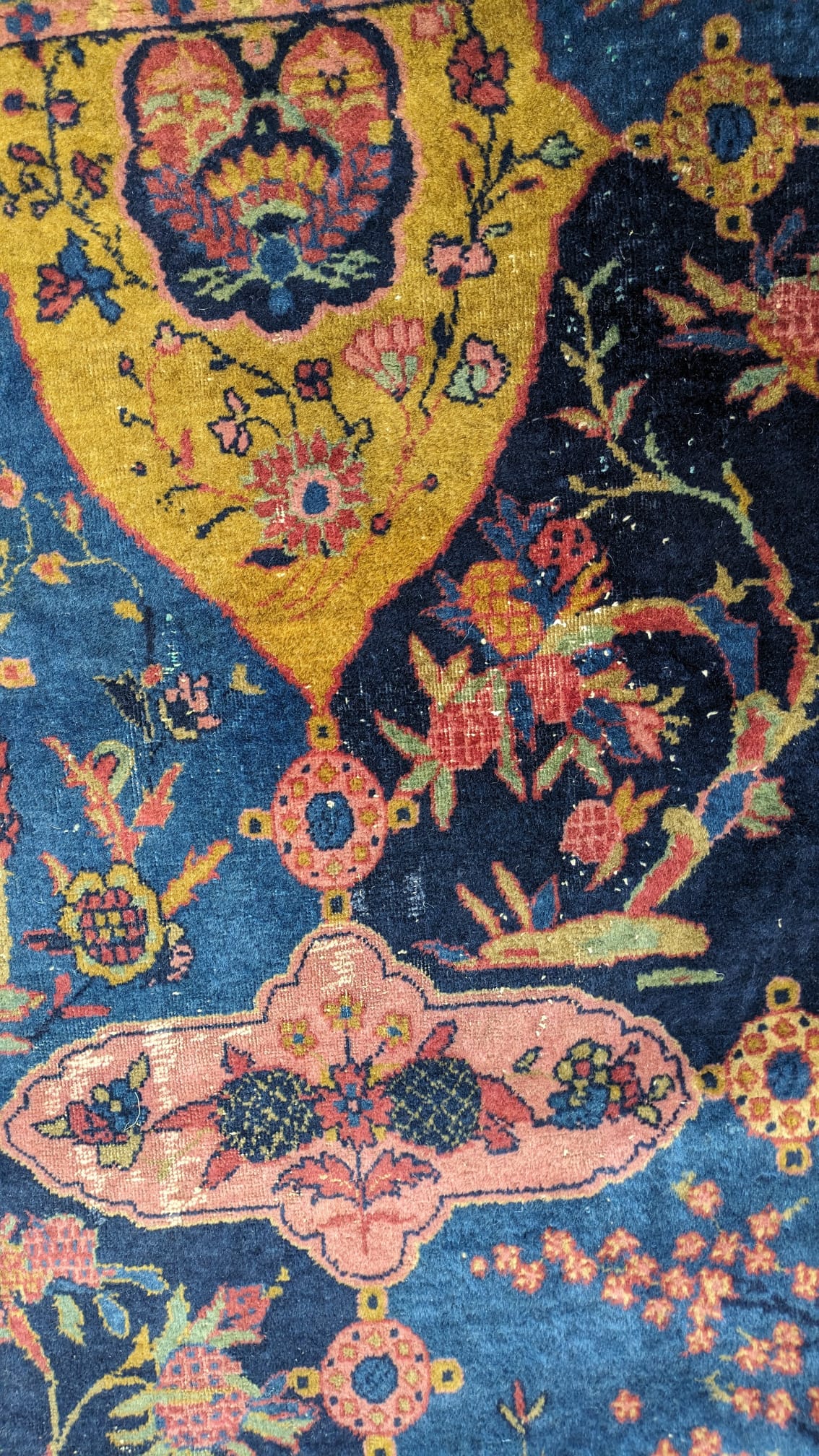 A Khorasan Mashhad red ground carpet, circa 1930’s, with field of stylised floral motif medallions, multi-bordered, 545 x 400cm. Condition - fair